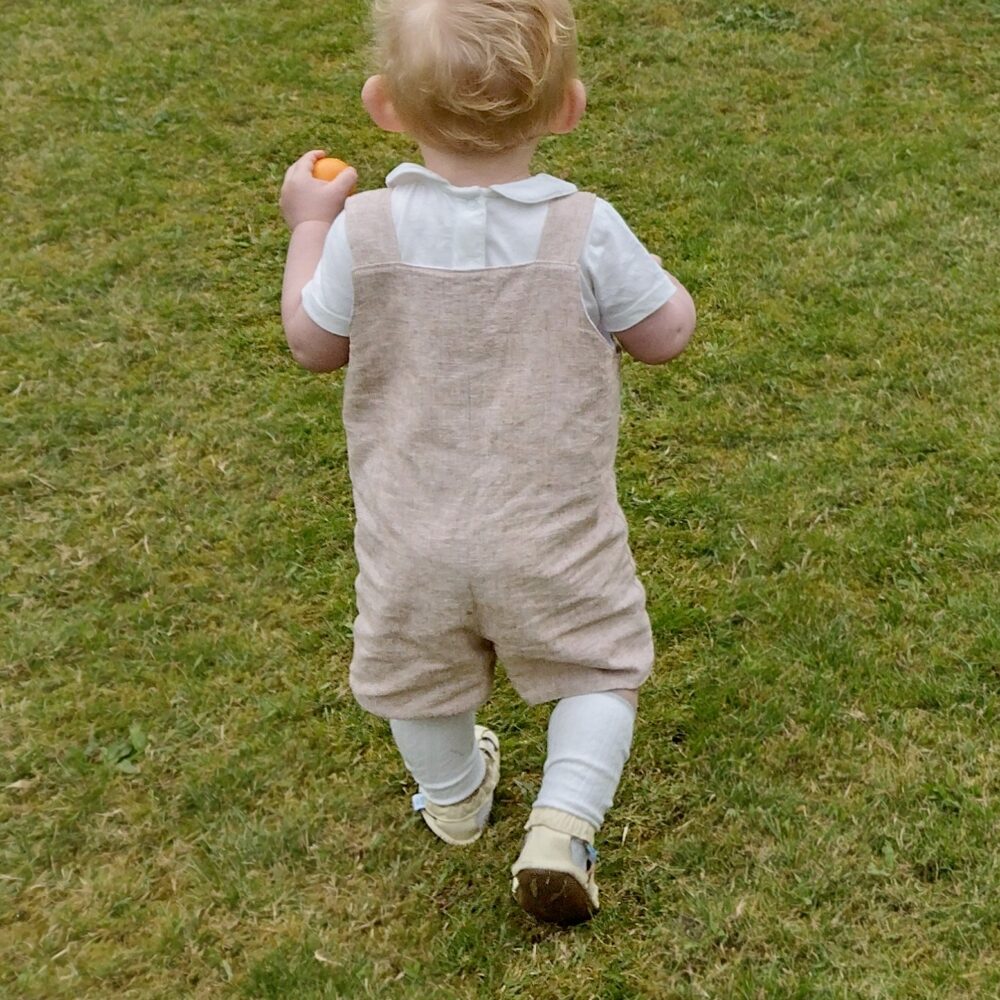 Natural linen baby boys romper being worn