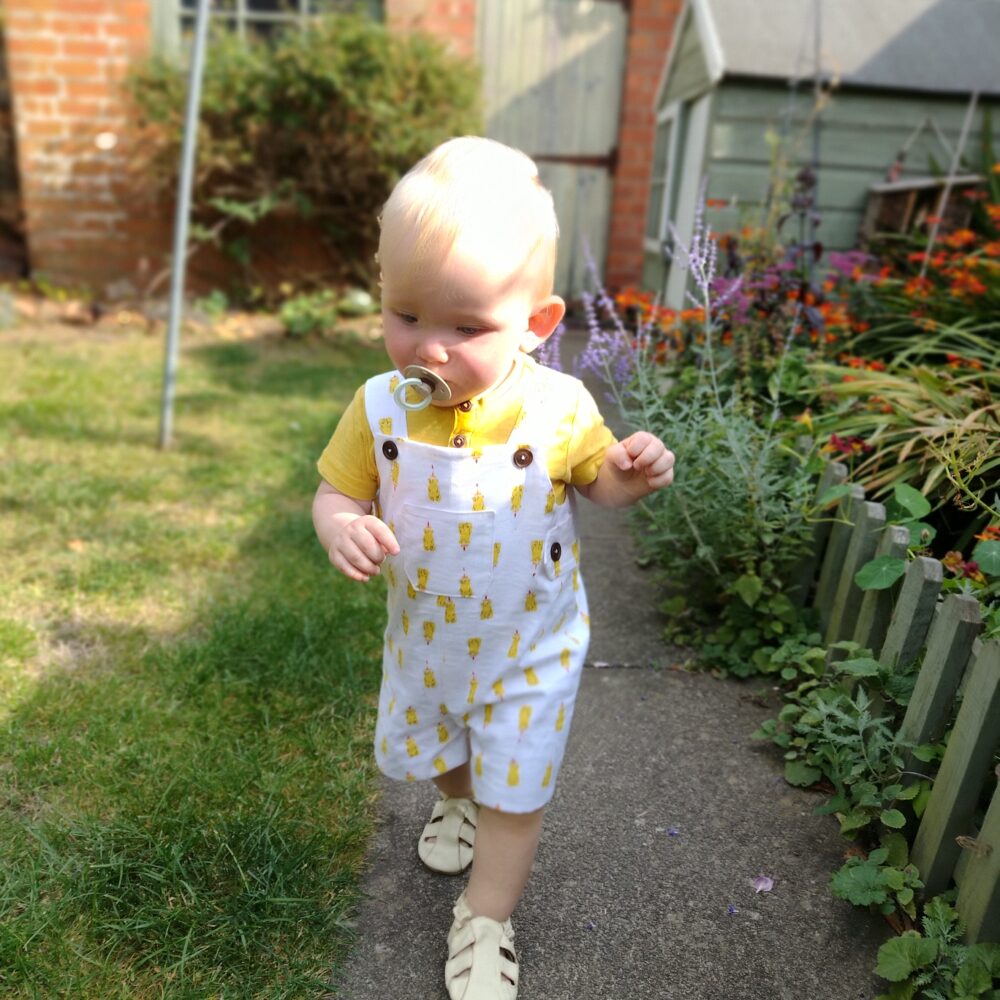 White cotton baby boys romper with yellow honey bear bottle print