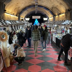 This image shows a large tunnel space filled with stalls for London Makers Market.