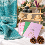 Spuggy Designs stall selection: knitted blankets, lanolin soaps, soy wax candles, and journals.
