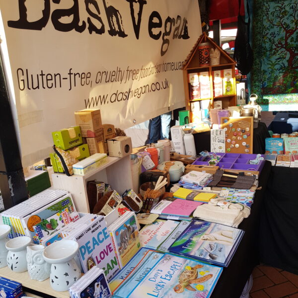 Chesterfield Vegan Market - Side shot of Dash Vegan's stall featuring a range of giftware including oil burners, children's environmental issue books, eco homewares, plastic free and zero waste lifestyle goods, herbal teas and chocolate bars. All vegan.