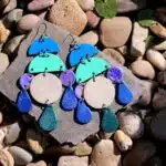 Large dangly earrings with semi circles, circles and rain drop shapes in blues and turquoises.