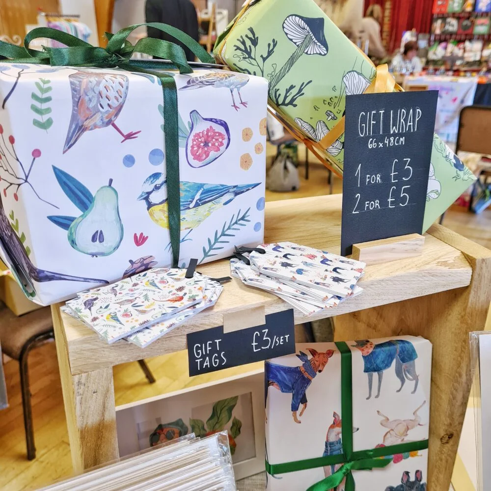 Gift wrap with birds, plants, mushrooms and sighthounds
