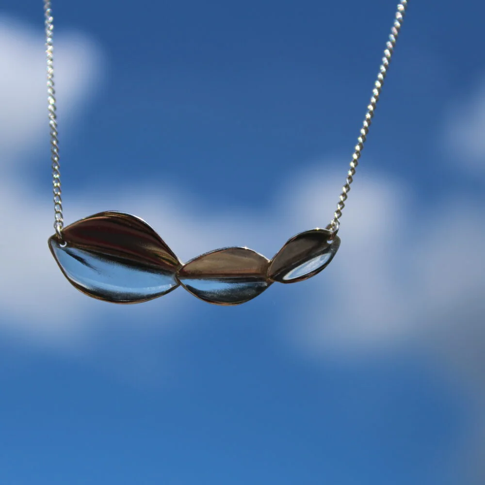 Blue cloudy sky with sterling silver 3 leaf necklace - left leaf is larger and each leaf gets smaller along the bar