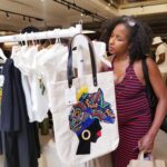 Black Culture Market, London. Lady looking at a tote bag.