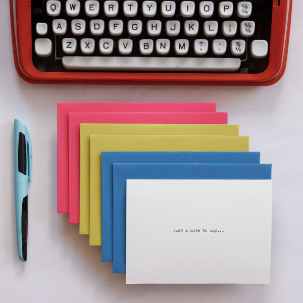 Brightly coloured envelopes and notecards wtih a typed font