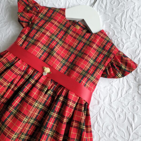 Christmas tartan dress, in 100% cotton. Has a capped sleeve, red ribbon sash and 3 gold popper fasteners. Handmade by Audrey's Attic
