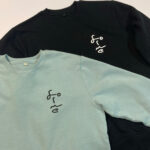 Forme Prints, green and black sweatshirts with faces on the left breast