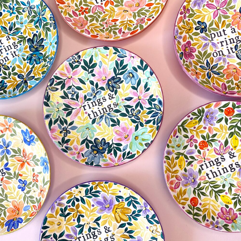 A selection of hand painted floral trinket dishes with text 'rings & things' on them.
