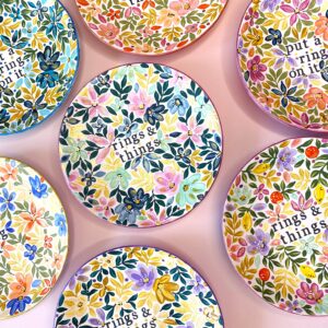 A selection of hand painted floral trinket dishes with text 'rings & things' on them.