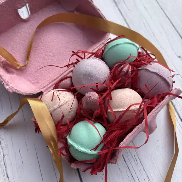 An egg box full of small bath bombs, wrapped up with ribbon