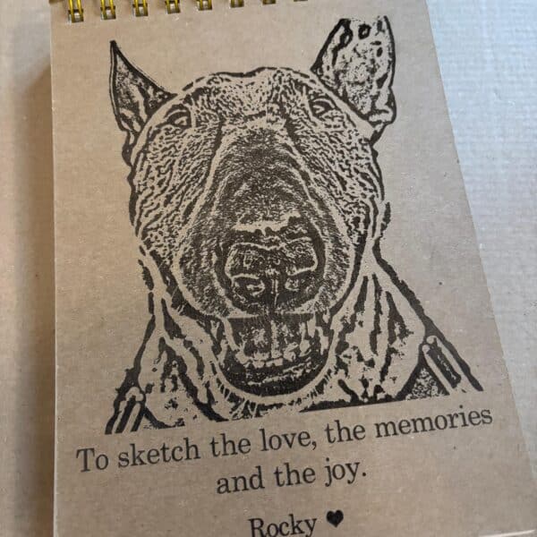 Laser-engraved A5 sketchbook featuring a personalised name and message, with a custom pet image design.