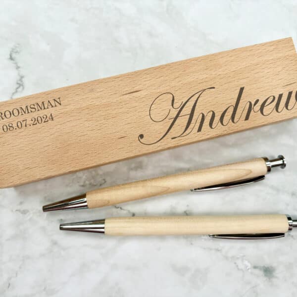 Laser-engraved wooden wedding pen set featuring a personalised name and date, for gifts for groomsmen.