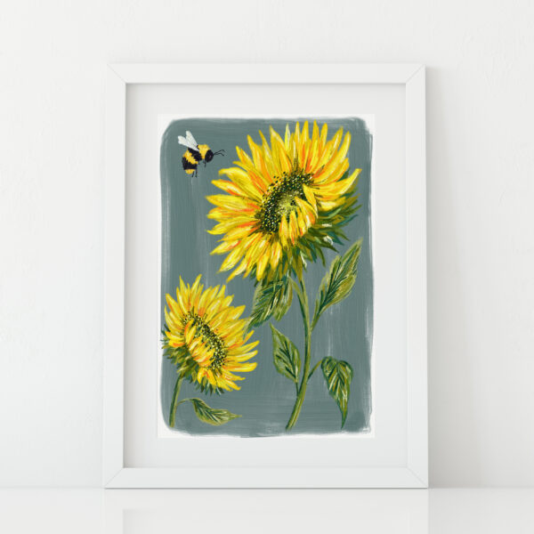 Sunflower print with bumble bee on a grey background, shown in a white frame by Ellie Cartlidge Design