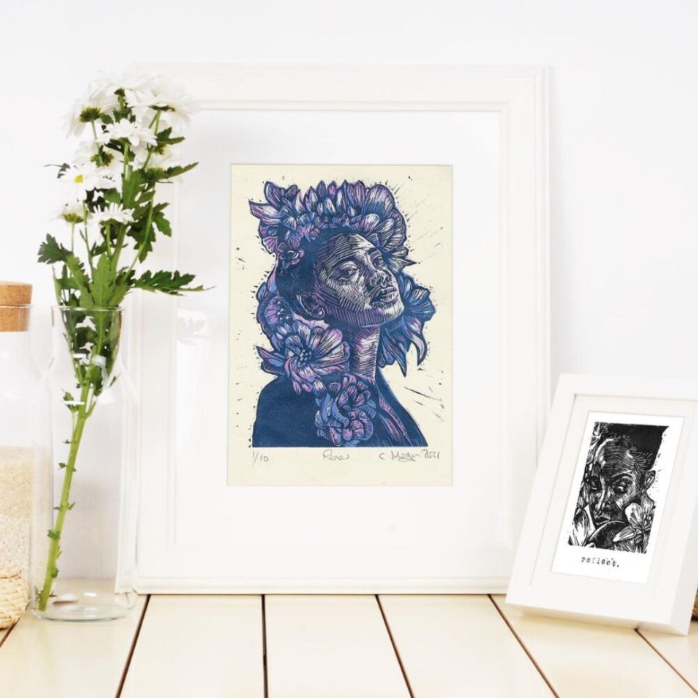 white minimalist interior with 2 frames portrait artwork reduction print with portrait with floral elements.