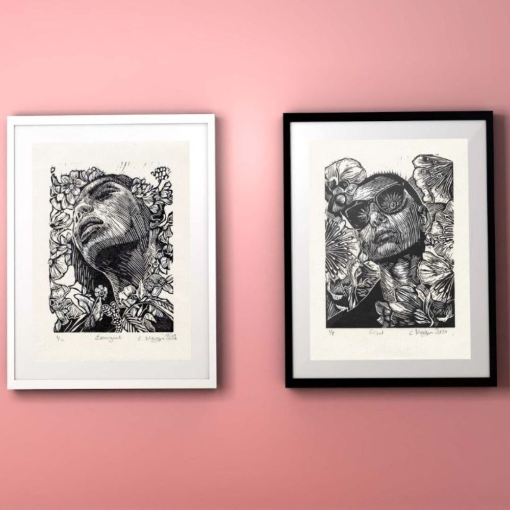 Monochrome figurative linocut print artwork. portraits in nature Diptych on pink wall. black frames