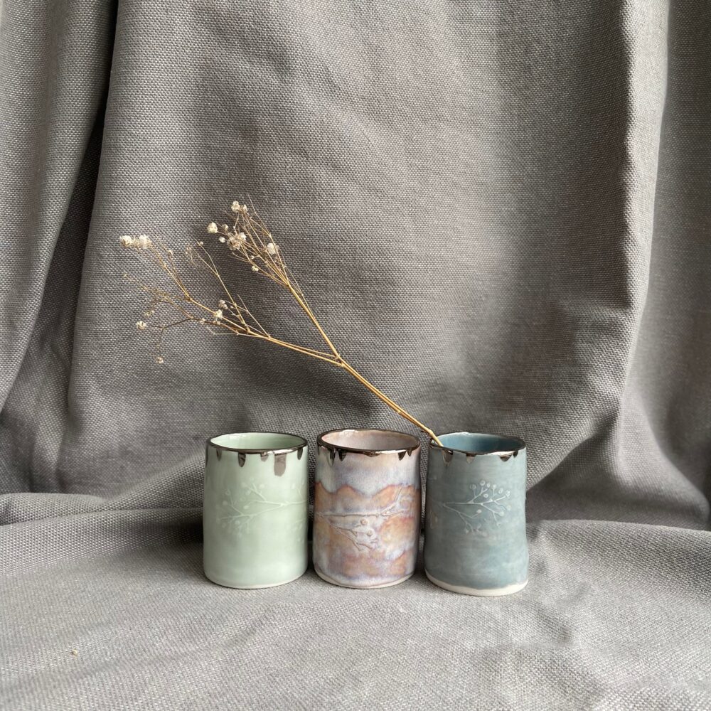Handbuilt mini planters with relief design of gypsophila around middle glazed in pastel colours with metallic rim