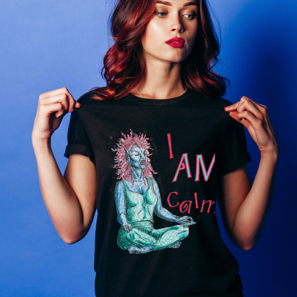 Woman in front of a blue background, wearing a black -shirt with the graphic "I Am Calm!" printed across the front.