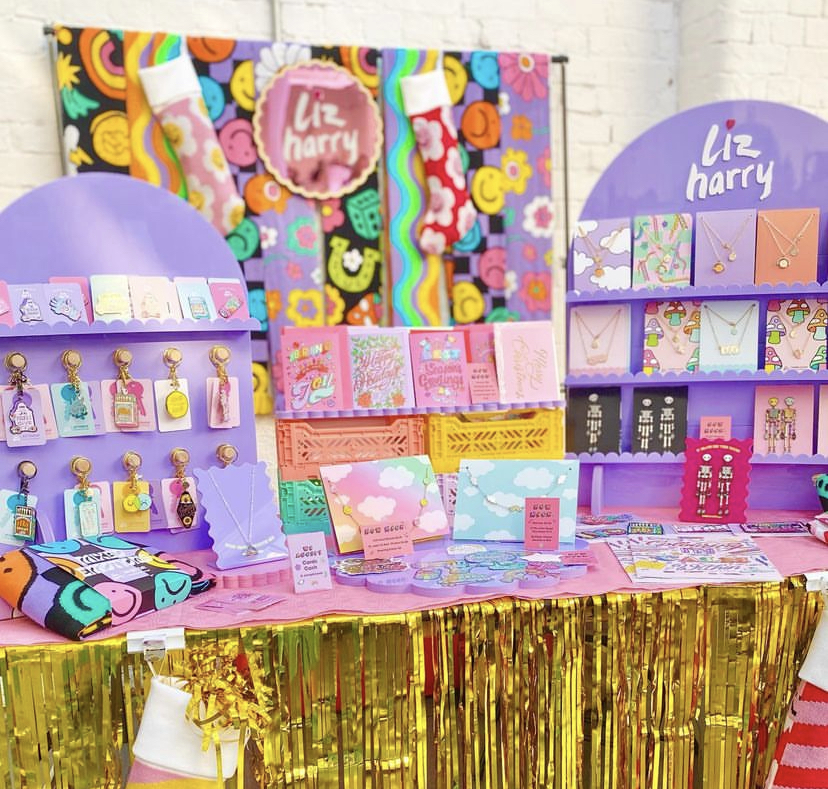 Liz harry stall - lots of gold streamers and pinks and purple