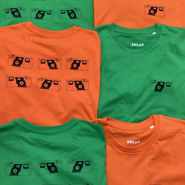 Bright orange and bright green t-shirts that feature a print of disposable cameras
