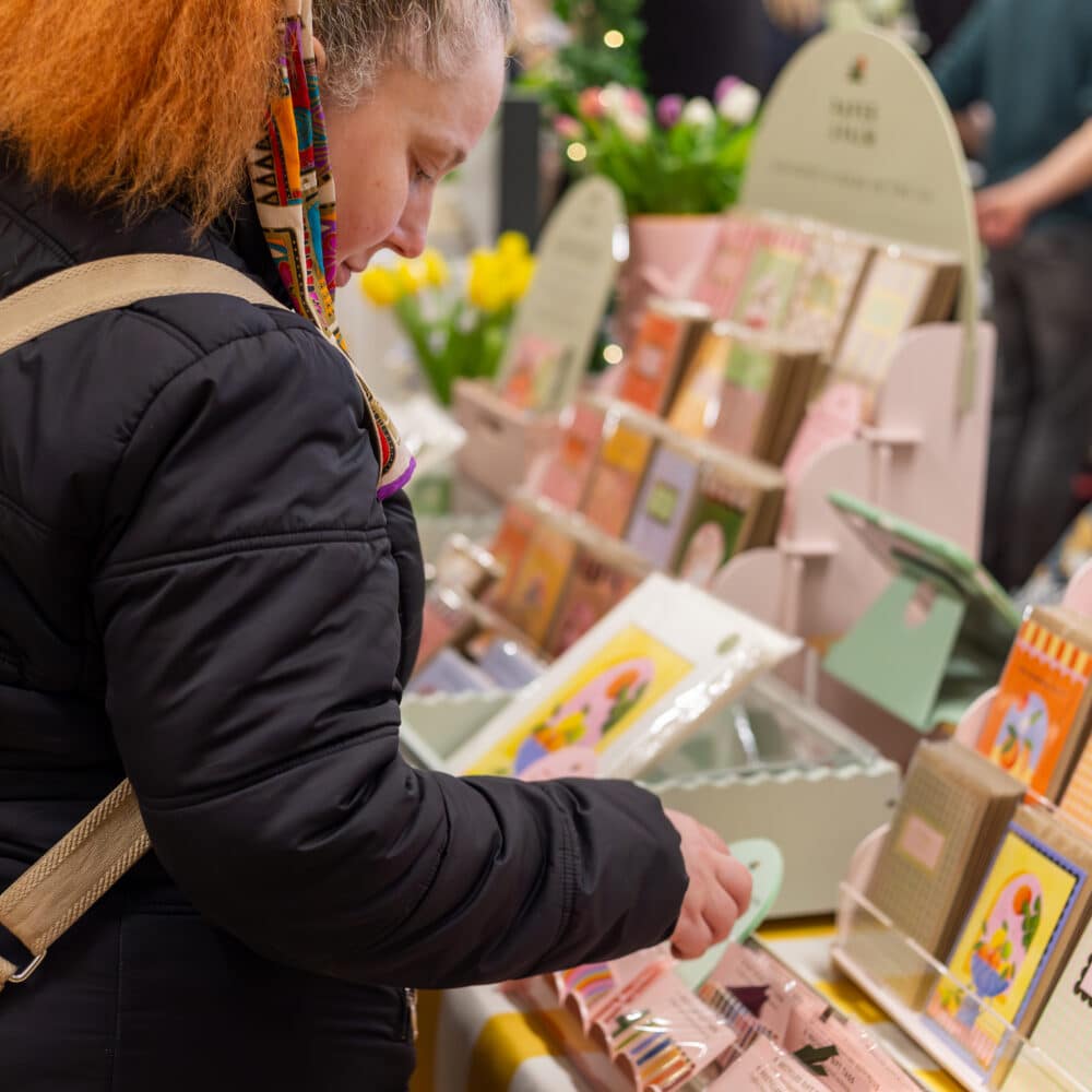 A visitor shopping for unique cards at the Paper Daisy Shoreham Market