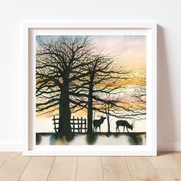 a square painting in a white frame with a colourful sky, several trees, a fence and stags in silhouette