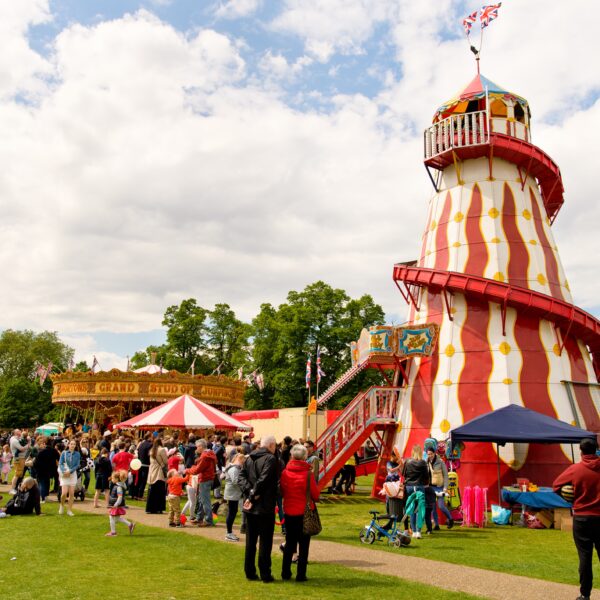A red and white striped helter skelter at a fair.