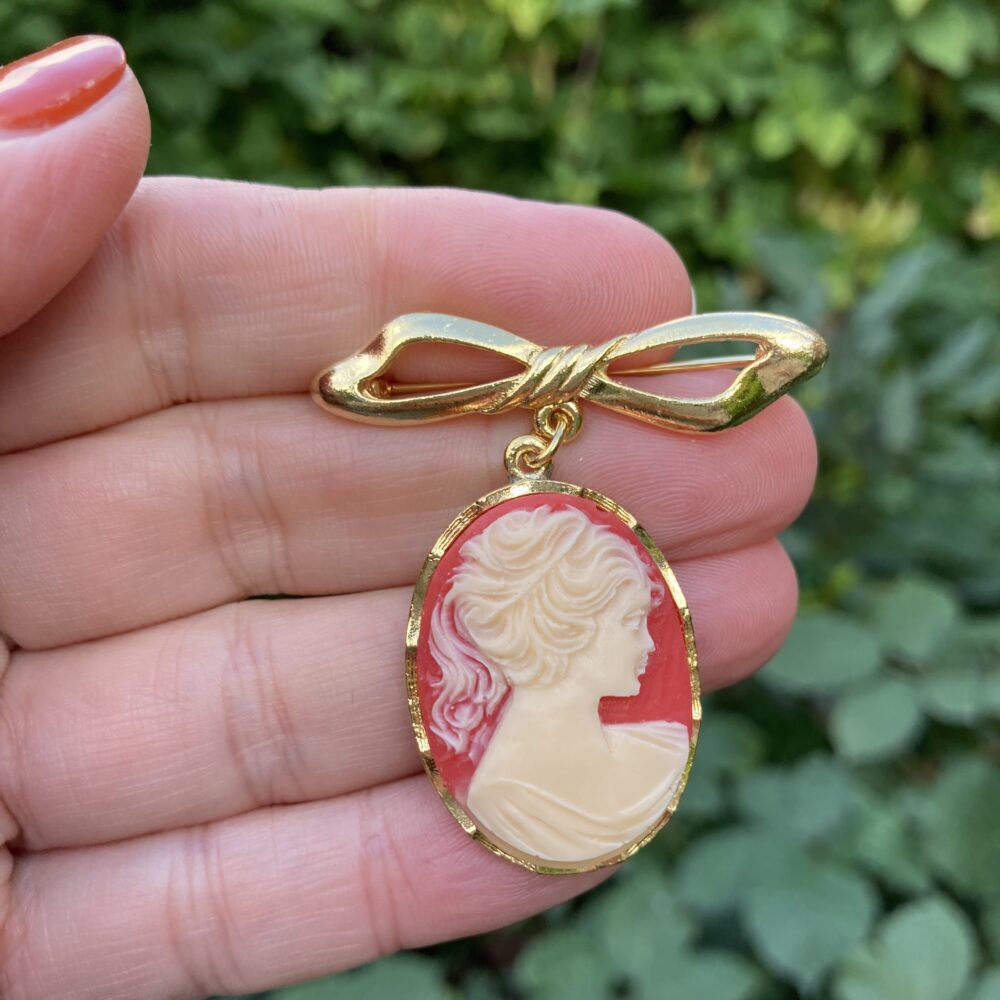 Vintage cameo brooch drop from bow.