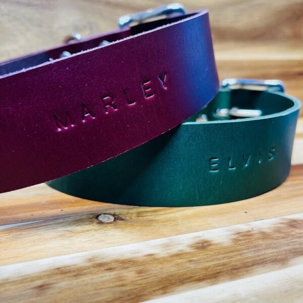 The words MARLEY and ELVIS stamped into plum and green leather