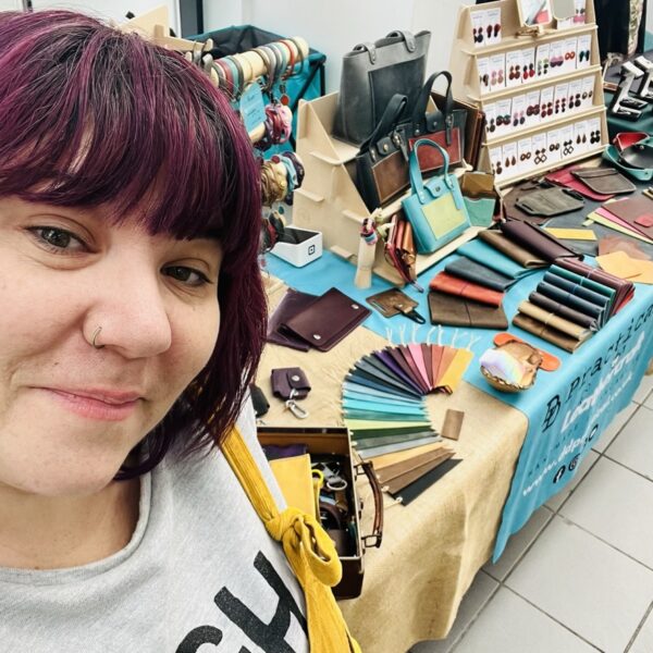 Dani standing next to her leather stall