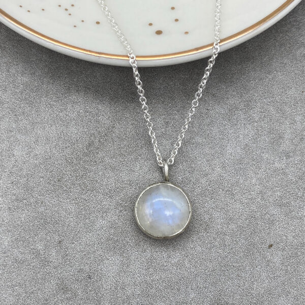 Round rainbow moonstone pendant with silver chain. Handmade by Tori Foster
