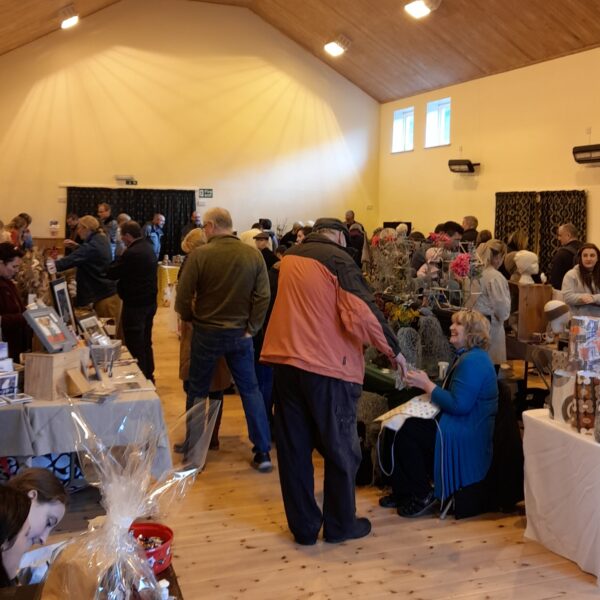 A busy Village Hall with stalls from various artisan makers