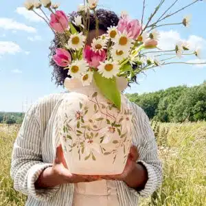 Natasha Samasuwo holding a vase she handpainted