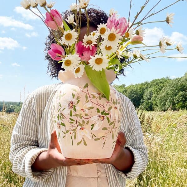 Natasha Samasuwo holding a vase she handpainted