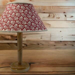 A large cone shaped lampshades with a beautiful floral print. The lamp base was designed and made by us