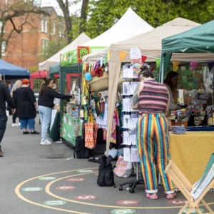 Craft Markets in Yorkshire - image shows a colourful line of market stalls and people browsing