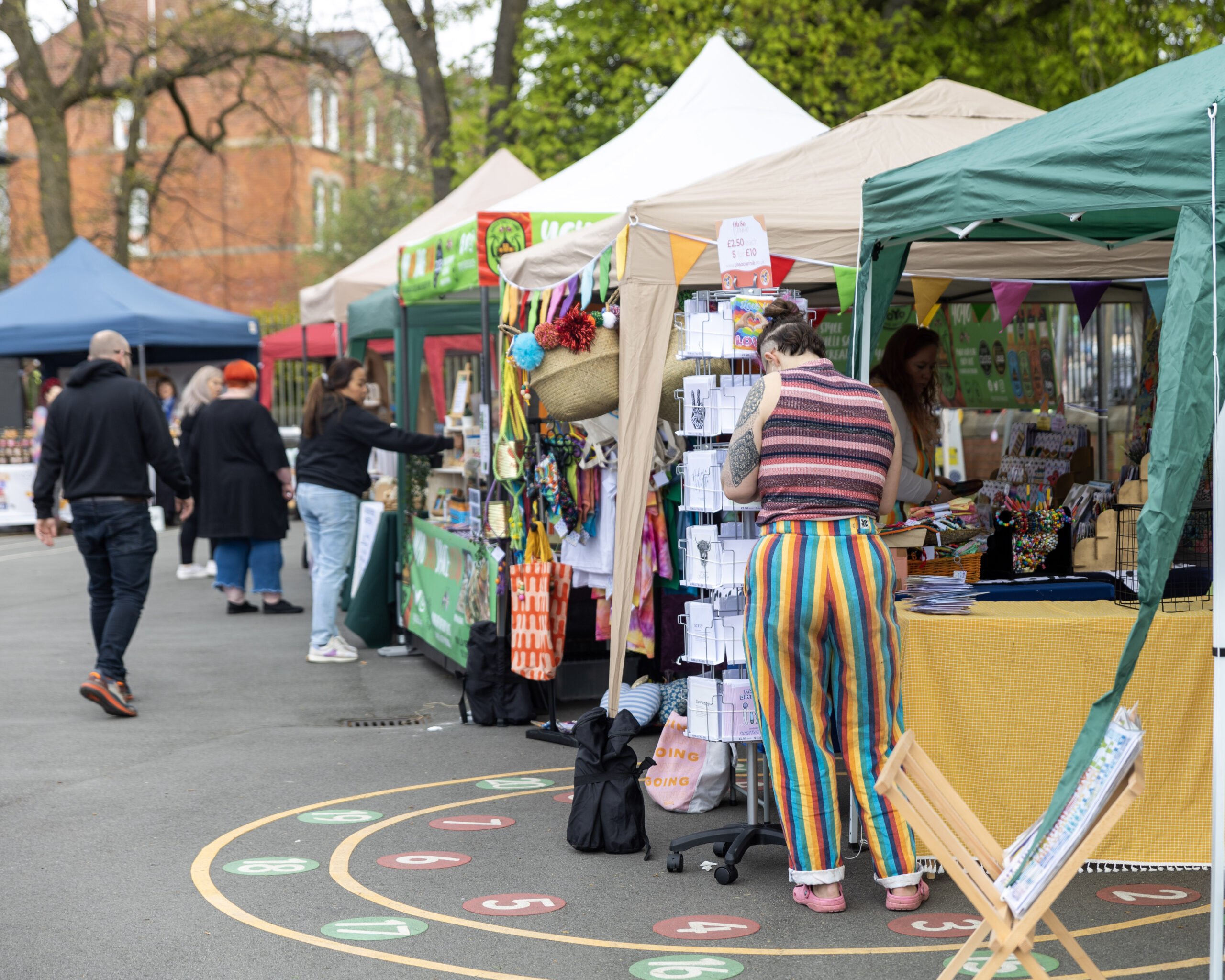 Craft Markets in Yorkshire - image shows a colourful line of market stalls and people browsing