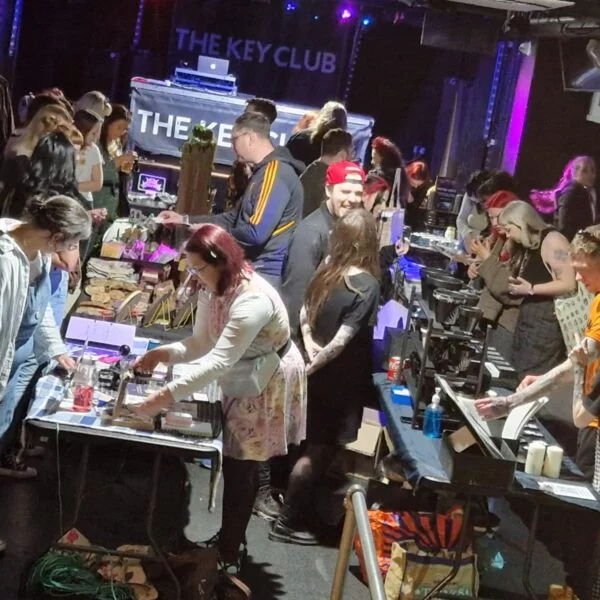 image shows the key club's first gig room filled with stalls and packed with shoppers