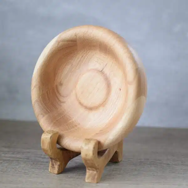 wooden oak dish displayed on a wooden plate stand