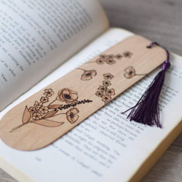 wooden pyrography bookmark displayed on an open book