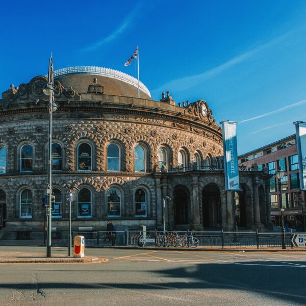 image shows the outside of Leeds Corn Exchange surrounded by blue skies