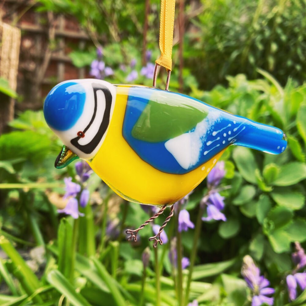 Handmade bird called a Blue Tit that has been made out of glass and fused together in a kiln.