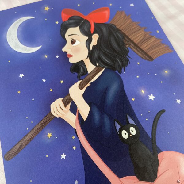 An A5 print of a digital illustration. The image features Kiki and her cat, Jimi, from Kiki's Delivery Service. Kiki is holding her broomstick and looking up at the night sky. Fiji is sat on her pink bag with his usual startled expression.