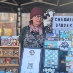 Charming Badger stall featuring greetings cards, wooden pins and mugs