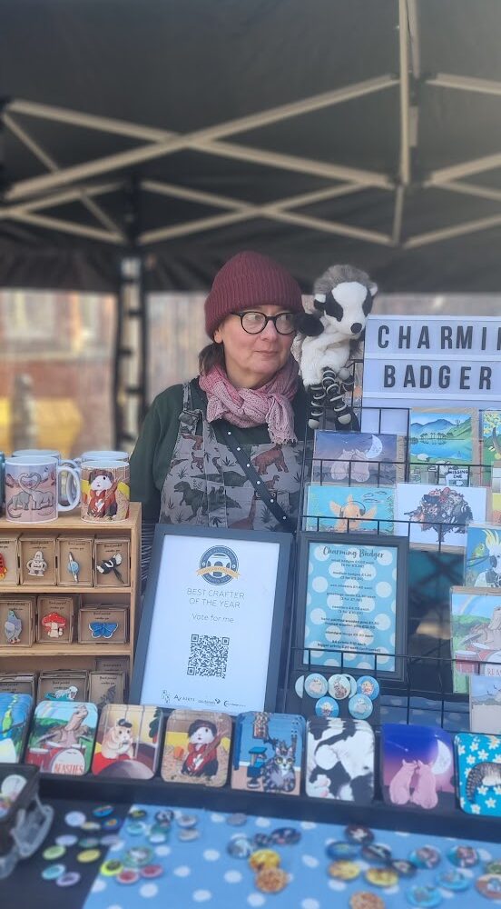 Charming Badger stall featuring greetings cards, wooden pins and mugs