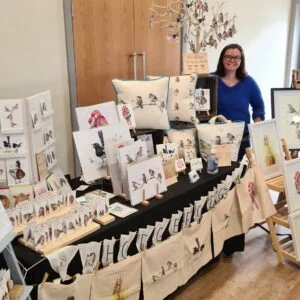 An example of one of my indoor stall set ups, a table with lots on display and me standing proudly behind.