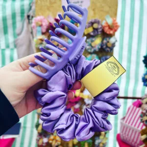 A lovely handmade satin hair scrunchie in a lilac colour from Abi Through The Ears with matching hair claw clip in purple.