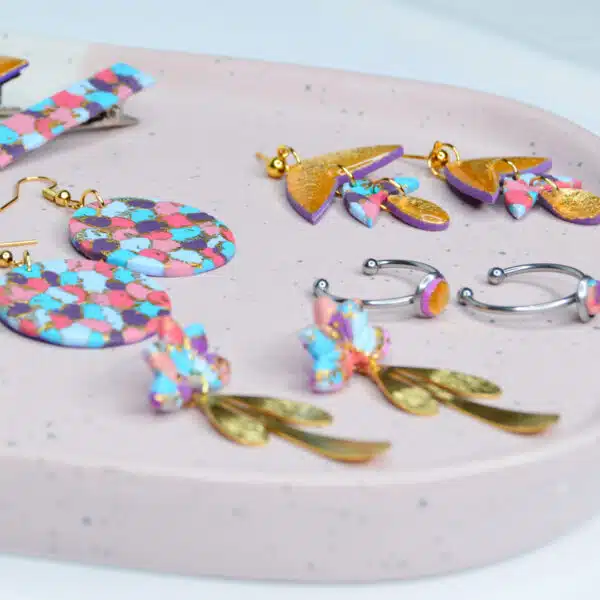 Polymer clay earrings and rings in bright bold pinks, blues and purple