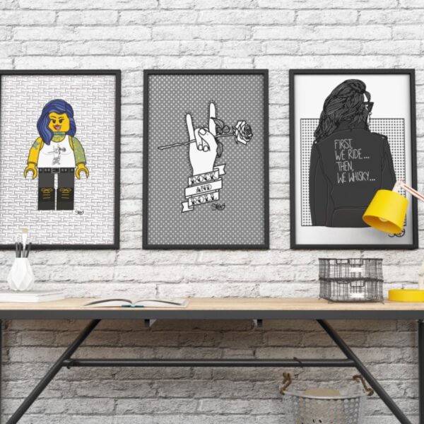 A display of three framed Stoofy art prints. One of a lego inspired figurine, one of a rock and roll hand gesture and one of a woman in a biker jacket stating @first w ride, then we whisky" - a suggestion of how to display the art prints in the home.
