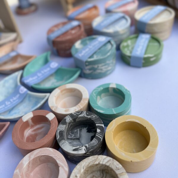 Close up of various coloured tea light holders and coasters